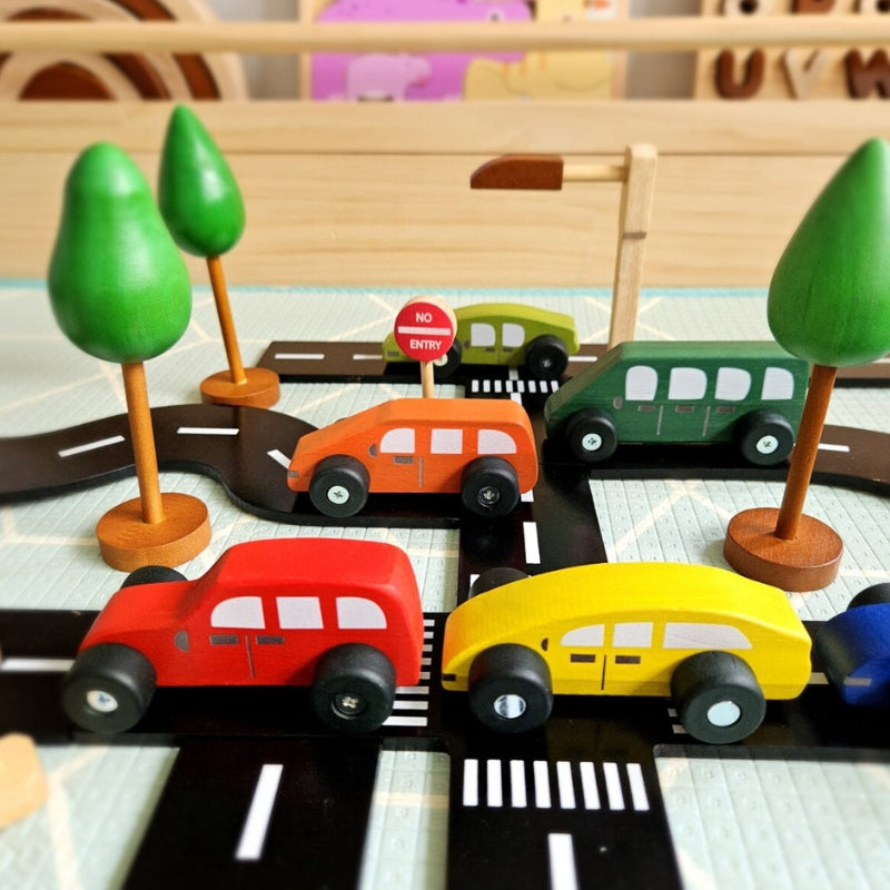QToys - Coloured Wooden Cars - Wooden toy cars on a road with trees and a no entry sign. 